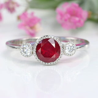 Bright red ruby in three-stone platinum setting