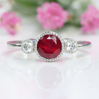 Ruby engagement ring photographed against foliage