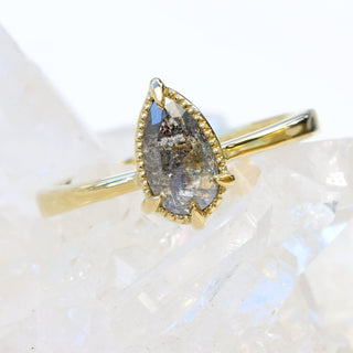 Angled front view of salt and pepper diamond solitaire 18ct gold ring