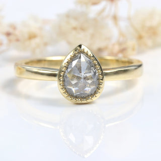 18ct gold pear cut salt and pepper diamond ring photographed on pale background