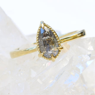 Angled front view of salt and pepper diamond solitaire 18ct gold ring