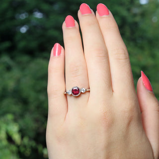 Handmade Ruby engagement ring on the hand outdoors