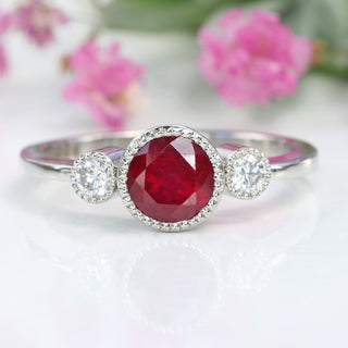 Bright red ruby in three-stone platinum setting