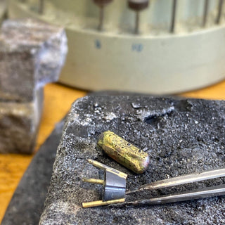 Artisan jeweller creating bespoke yellow sapphire engagement ring in 18ct gold UK.